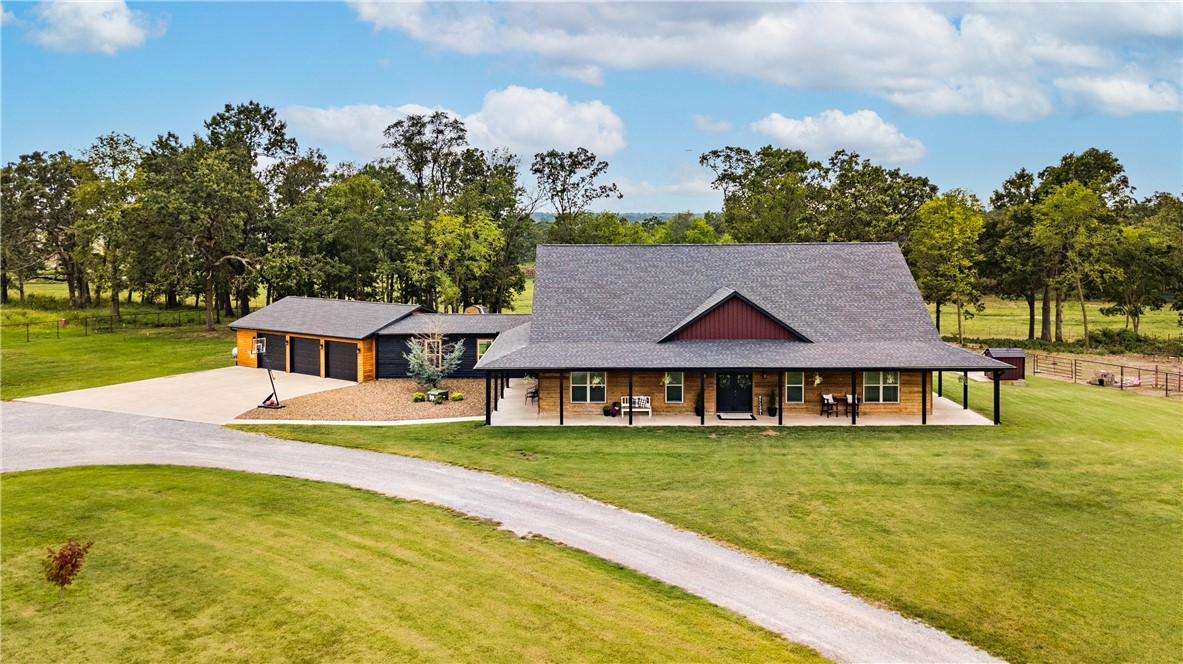 Experience Tranquil Country Living at 13975 Shady Acres Road! Situated on 5 picturesque acres in Bentonville, AR, this newer 4-bedroom, 3.5-bathroom home offers both serenity and convenience. The open floor plan features a dedicated dining area, a modern kitchen with unique raw edge granite countertops, stainless steel appliances and a hidden walk-in pantry. Split floor plan all on one level with 3 bedrooms have ensuites! The primary suite is a private retreat with a spacious walk-in closet and an ensuite bathroom, dual vanities, large walk-in, tiled shower. Heated flooring throughout the home that is heated with eternal broiler. Enjoy the expansive grounds with an inground saltwater pool, perfect for entertaining or relaxing. Additional highlights include a 1200 sq ft 3-car garage and a 2100 sq ft heated/cooled workshop with water. Located just a short drive from local amenities and schools, this property offers a peaceful escape with easy access to everyday conveniences. Don’t miss this serene slice of paradise!