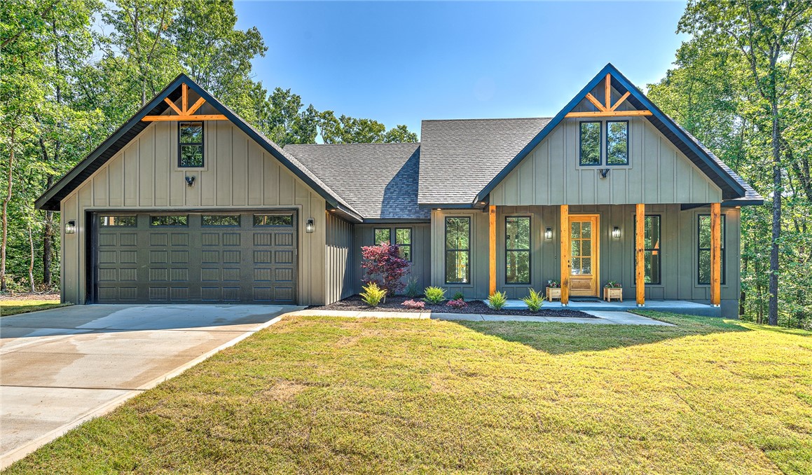 Wonderfully Designed New Construction Modern Farmhouse built with a great open and spacious split floor plan, Features clean and sleek black alabaster white color scheme. 10 Ft ceilings throughout most of the home, Custom beams in LR and Primary BR, Oversized 8 Ft doors and beautiful luxury Vinyl Flooring throughout, The Kitchen boasts Custom Cabinetry and 8 Ft Luxury Quartz Counter tops, Gas Stove, Huge Walk-In Pantry with hideaway plugs for appliances, Enjoy Elevated trim throughout with fully cased windows and openings, custom closets. Primary Bath offers ample storage and Cabinet space, The guest bath includes Tiled Shower with Custom Shelving for extra storage, Epoxy Coated Garage Floor, Spacious Covered front and back decks/patio overlooking Professionally landscaped and sodded yard situated on a flat lot and located in highly desired area with the Down Under LP Trail Access adjacent to home.
