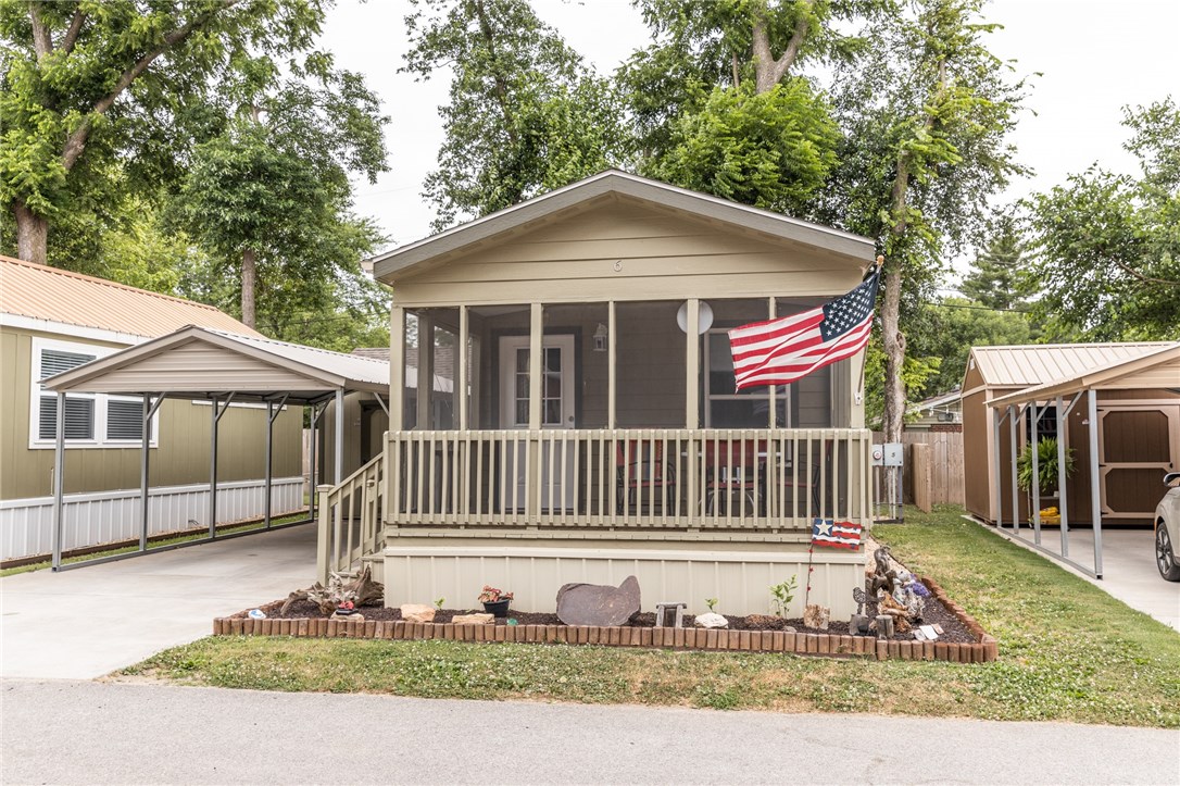 Tiny home! This fantastic and cozy Tiny home comes with all the appliances. Enjoy the evening breeze on the screened in porch. The carport and shed Covey with the property. If you are 55 and over looking for a great community and environment to live in near downtown Rogers this will be perfect for you. Extremely low maintenance to no maintenance. You pay a lot rent of 350 a month and your power bill, those will be your only expenses.