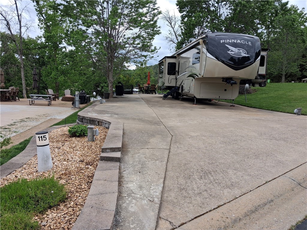 Welcome to your perfect getaway at Ozark RV Resort overlooking beautiful Table Rock Lake! This spacious back-in site offers full hookups and is thoughtfully designed for comfort and convenience, making it ideal for weekend escapes or extended stays. Enjoy stunning lake views right from your lot, surrounded by well-maintained landscaping that adds to the peaceful, resort-style atmosphere. The resort is packed with top-tier amenities including walking trails, activity center, 2 pools, pickle ball and a fitness center. For you outdoor enthusiasts, the location is unbeatable—Table Rock Lake is known for its serene sunsets and fantastic fishing opportunities, making it a dream destination for anglers and adventure seekers alike. **2021 Pinnacle 5th wheel available at additional cost