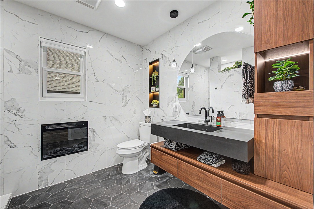 If location and style are at the top of your list—you cant miss this one! This fully remodeled 4-bedroom, 2-bath home is tucked into an unbeatable spot near schools, Coler Trail, 2.4 miles to Walmart Campus and the Razorback Greenway, giving you instant access to some of the best outdoor living Northwest Arkansas has to offer.
Inside, you’ll fall in love with the beautiful modern updates, open feel, and natural light that pours through the space. Every detail has been thoughtfully designed to create a home that feels both elevated, warm and inviting.
This home isn’t just a place to live, it’s a lifestyle.

Please note: Full remodel! Some furniture, yard play equipment, garage storage, plastic storage shed, pergola can be negotiable with acceptable offer. ***Matte green appliances DO NOT CONVEY! Seller will replace with Stainless Steel appliance package. They could potentially be purchased separately. Refrigerator units in garage DO NOT CONVEY***