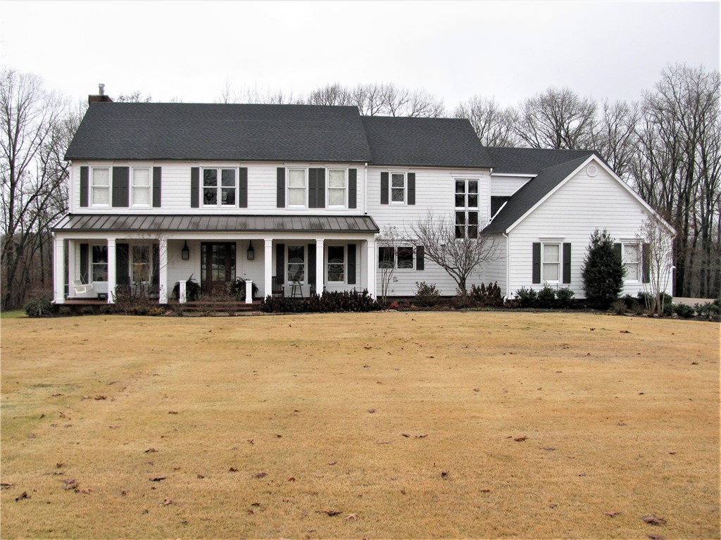 Beautiful estate home on 4.17 acres. Scenic paved drive through meadows surrounded by woods, cross bridge over Artesian spring, up small incline to the estate on large flat yard surrounded by natural wooded setting. Private location just few minutes to Hwy 72 & I-49. Only 3.5 miles Downtown Bentonville. Home updated throughout, upscale/magnificent, lots woodwork, extravagance/detail, yet comfortable with warm/inviting features; tall ceilings, wood floors/beams, 2 fireplaces, 2 staircases, lots built-ins, gourmet kitchen with magnificent island, stainless appliances: built-in refrigerator, gas range with griddle, microwave/convection oven combo, soap stone countertops. Home has 5 bedrooms, 4.5 baths, 2 living areas & study on main level; upstairs bonus room. 5th bedroom lower level has sink & microwave. Formal dining plus large breakfast area. 4 garage, large porch, huge deck, stone patio. Roof 2019. Hardie pre-painted exterior siding 2016. Two of the three HVACs replaced 2019. Septic tank recently inspected/pumped.