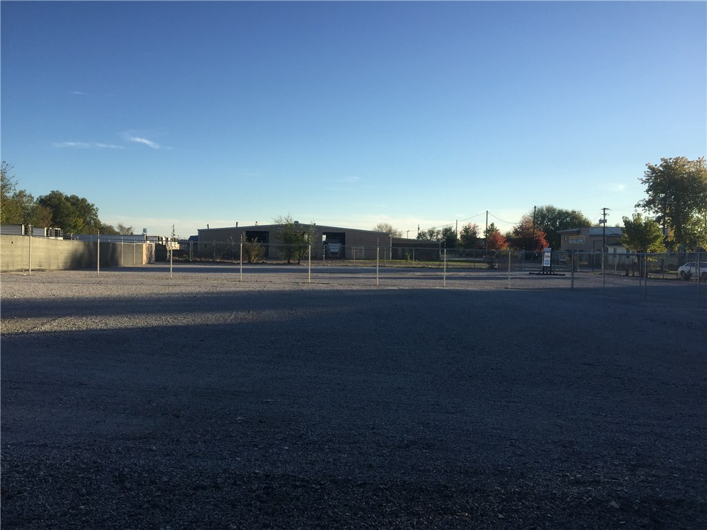 Fenced in lot right in the heart of Springdale!! Perfect investment lot for a business or a lease out. Electric & water available. Currently leasing for $1,450/ month.  There is currently a 36” portable office building that has been wired and insulated. It is currently being used as an office. It has a security system and wall a/c and heater. It has 2 loft areas inside.