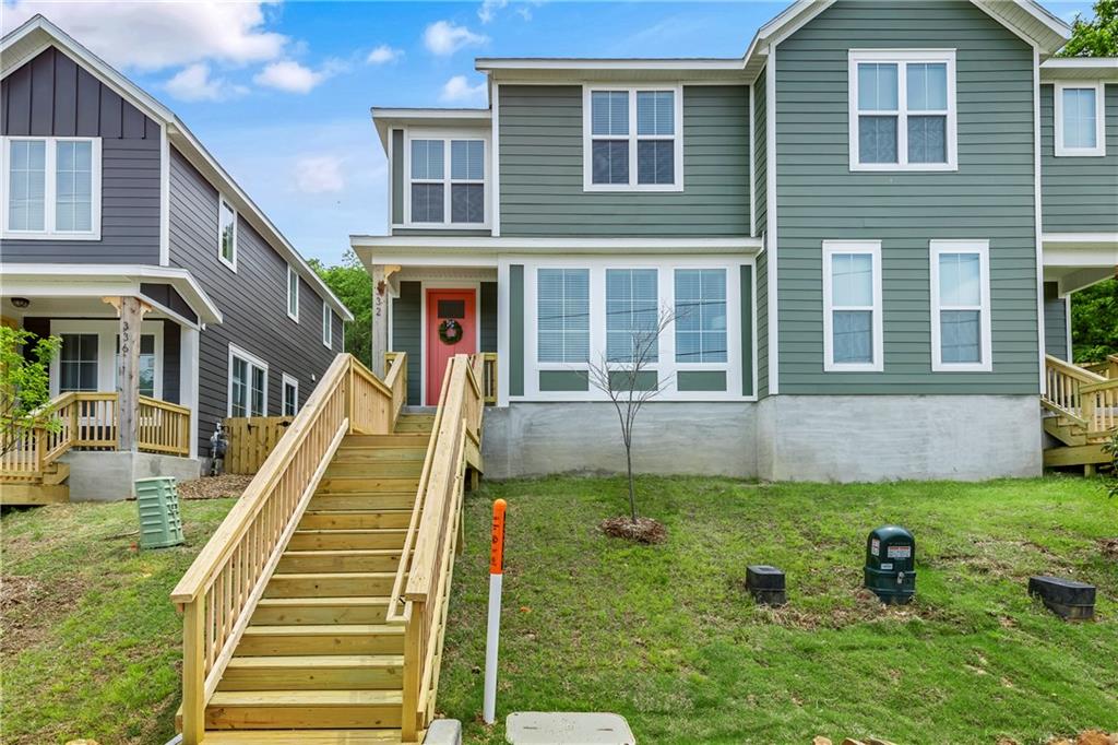 Architecturally designed 3 bed 2.5 bath townhome located at the north end of Dickson St; Just blocks from Fayetteville Downtown square and Dickson St entertainment district. The spacious eat-in modern kitchen features quartz counters, custom cabinets, under cabinet lighting, gas range, SS appliances, and large island with breakfast bar. Large living room offers views of campus and downtown. Primary bedroom with ensuite provides walk-in tile shower, double vanity and oversized walk-in closet. Two additional bedrooms and full bath complete the second level. Overall features 9 foot ceilings on both levels, nest thermostats, fenced yard and covered 2-car carport. Come tour this charming and conveniently located Fayetteville property today!