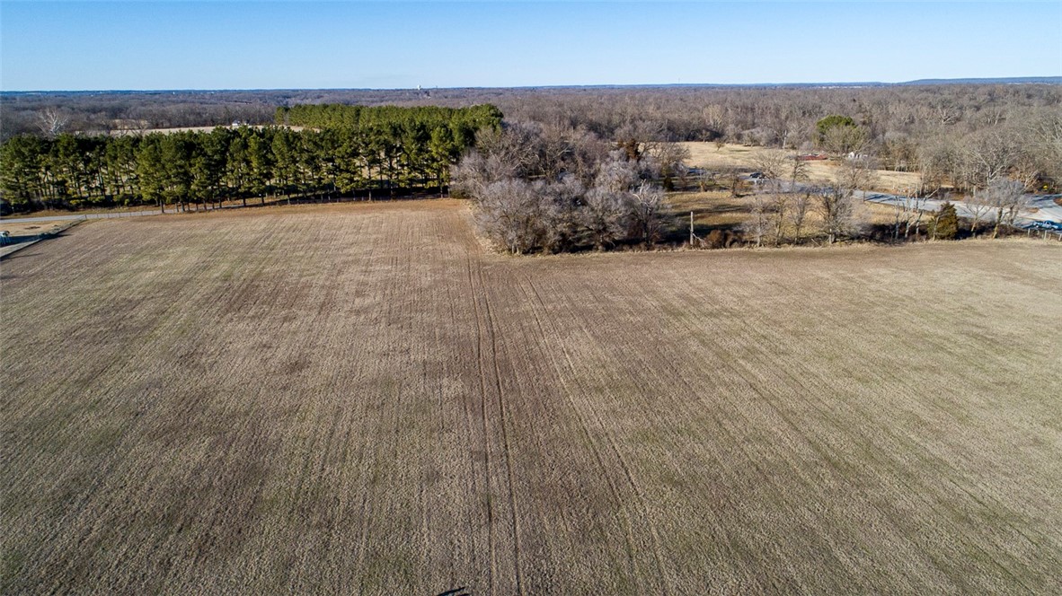 Executive Homes would be Perfect for 51.33 acres zoned for 3+ acre lots! Wooded & Open,Close to Rogers on Paved Road?Easy access!Gorgeous land,Get your family & friends and build some Dream Homes here!Development Potential. Electric, water and gas lines adjoin acreage. Get your family and friends buy it together and use it for yourselves! Strong development potential! acreage fronting Hwy 94 between Rogers & Pea Ridge. Rock ledge with spring. Daffodils encompass the old home site and extend all the way out to Hwy 94. The seller has created trails through the gorgeous wooded area. Wonderful area for upscale homes with larger lots, also smaller home development potential. Great place to build that hobby farm. Situated across Hwy 94 from Brush Creek Hills north entrance, on top of hill! There is plenty of room for entry and exits off Hwy 94.  The parcel #’s are being changed due to the survey however Benton County will not change the parcel # until deed transfer so the parcel # is not correct in this information.