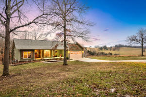 Almost new home with seclusion, views, and 6.53 acres.  Spacious master suite that includes a walk-in closet and 4 piece master bath and popular barn door.  The open floor plan allows for family time or is great for entertaining.  The covered deck looks out over the acreage with a calming view of the rolling landscape. The oversized utility room has a built in locker system for the owners coats and backpacks with an added utility sink.  Bedrooms 2&3 enjoy a jack/jill bathroom setup.  The partial basement includes a family room, bedroom4, full bath, safe room, and John Deere storage. Basement has a rustic cabin feel and main floor has a modern up to date decor style.   All of this close to town and 5 minutes to Walmart.