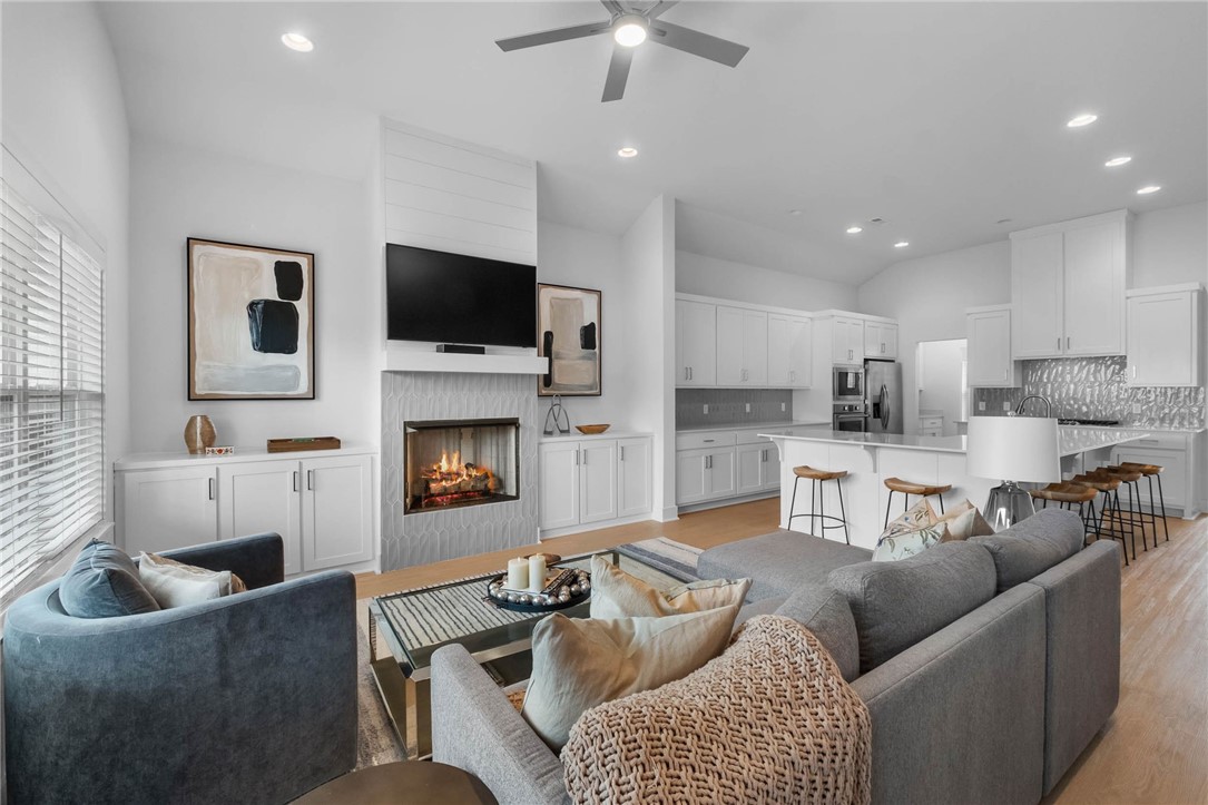 Nestled in the highly desirable Aurora community, this charming single-level residence offers an elevated blend of comfort & sophistication. The thoughtfully designed open-concept living & kitchen are anchored by an oversized island, complemented by a wet bar, walk-in pantry, & elegant dining space-perfect for both everyday living & entertaining. A split floorpan ensures privacy, w/ a serene primary suite & 3 additional bedrooms. Soaring ceilings, abundant natural light, & a timeless neutral palette create an inviting, move-in ready atmosphere throughout. Step outside to a covered patio & enjoy the private low maintenance outdoor retreat designed for relaxation. Residents of Aurora enjoy exceptional amenities, including an adult pool, family pool, splash pad, fitness course, sports court, playground & convenient dog wash station. Additional highlights include a rear-load garage and a $3,500 PREFERRED LENDER CREDIT-adding even more value to this exceptional home.