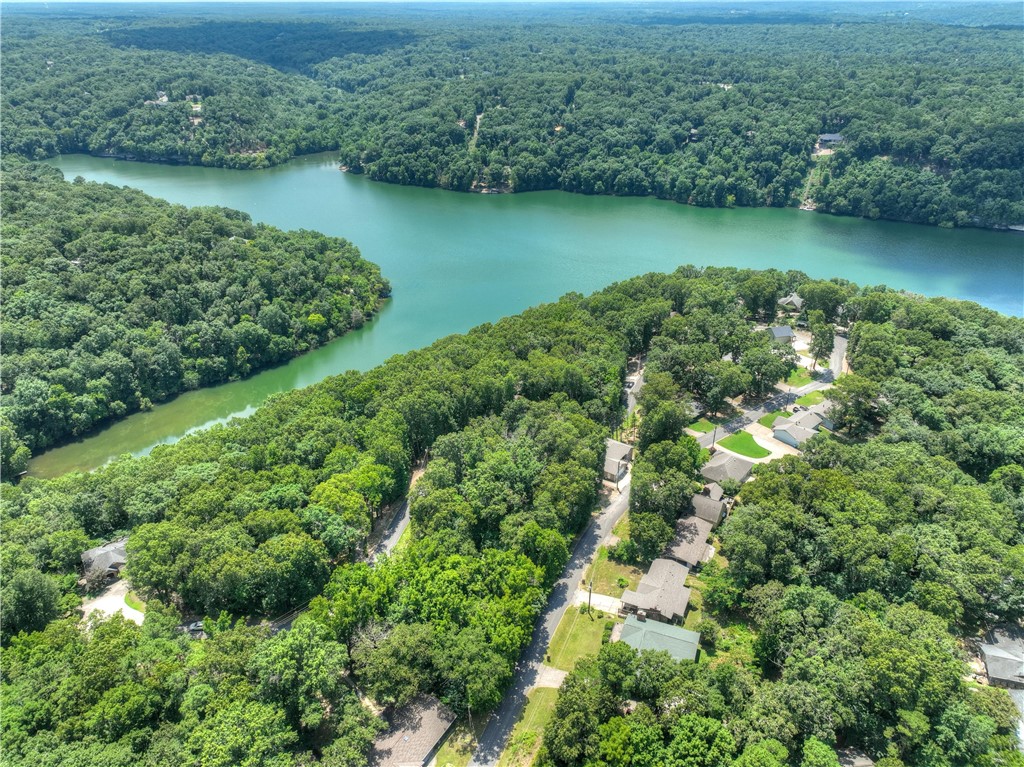 Build your dream home on this beautiful 0.28-acre wooded lot in the heart of Bella Vista! Featuring road frontage on both sides of Bosworth Circle, this gently sloping homesite offers flexible access and plenty of privacy with mature trees. Conveniently located on the east side of the Bella Vista Bypass, you'll enjoy quick access to Highway 71B, Bentonville, and everyday amenities while being surrounded by Northwest Arkansas' incredible outdoor recreation. Explore over 100 miles of hiking and biking trails, including the nearby Back 40 Trail System, along with six lakes, eight golf courses, parks, and recreation areas. Lake Ann, Bella Vista Country Club, Berksdale Golf Course, Bella Vista Town Center, and The Summit School are all just minutes away. Located in the highly desirable Bentonville School District, this is an outstanding opportunity to build in one of the fastest-growing and most sought-after communities in Northwest Arkansas.