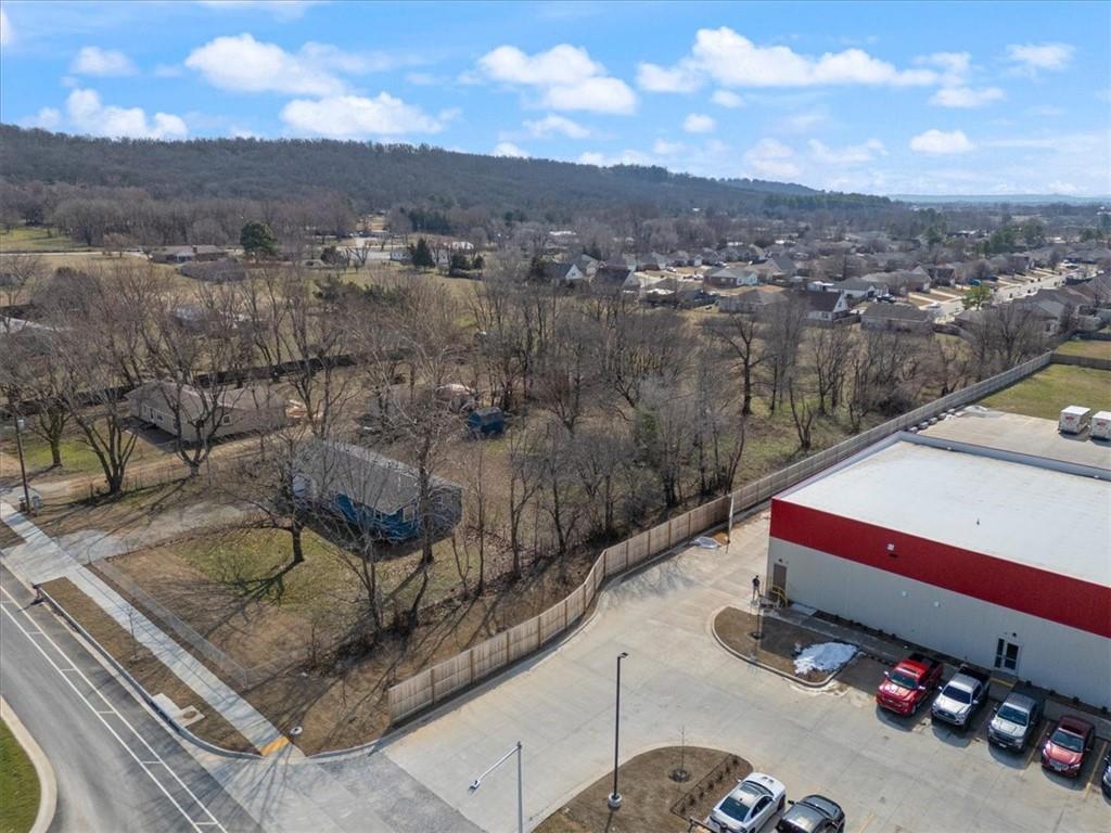 The property at 1303 Kendrick Avenue in Springdale, Arkansas, offers a 1.89-acre lot situated in a prime industrial park, ideal for constructing a city-approved commercial building. With approximately 124 feet of street frontage and a depth of 617 feet, it provides ample space for various commercial ventures. Notably, Kendrick Avenue is being expanded into a three-lane road to support ongoing development and will connect to Old Missouri Road, enhancing accessibility. This is priced with no value given to any structure or house