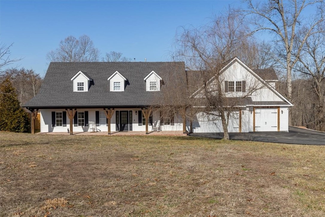 Welcome home to this charming Craftsman-style retreat, nestled on 2 private acres close to Coler Mtn. bike trails. Enjoy peaceful mornings on the covered front porch or entertain all summer in your in-ground swimming pool. This beautiful home features rich wood floors, crown molding, tons of natural light, a formal dining with wood pellet stove, and a large office/flex space. The kitchen is a dream with center island, granite counters, double ovens, undermount sink, and pantry. Upstairs you will find the primary suite, 2 additional bedrooms, and a very large bonus space with options to add another bathroom and kitchenette! The bonus space also features a private staircase to the 3-car garage area! So many options and opportunities to make this home fit your needs! Don’t miss the 29’ by 13’ encapsulated storm shelter and the 11X11 shed with roll up door/perfect for your future pool bar! Also available with 5.09 acres.