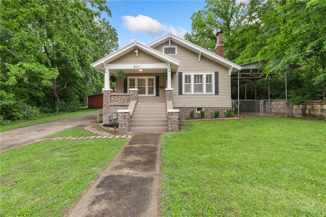 Anyone looking for a 3 bedroom, 1 bath, in town loaded with extras and a farm feel?  Check out 601 W Ridge AVE.  This gorgeously remodeled, craftsman style house sits on over a half acre, has a multi-level  972 sq ft barn/garage, a 65 foot long carport, a 75 sq ft storm shelter and multiple other outbuildings that would perfect for all your stuff.  This  home also has unfinished basement, newer exterior HVAC unit and a beautifully landscaped yard.  If you are looking for character and charm but want all the conveniences of modern living and proximity to healthcare and shopping, come check this one out.