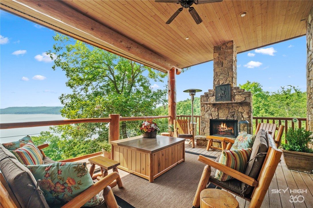 Encompassing 3 breathtaking acres set on peninsula w/600 ft of Beaver Lake frontage, this luxury log home is the ultimate, refined Arkansas retreat. The grand Douglas Fir timber-framed entrance opens to a majestic 2-story great room w/sweeping lake views & impressive stone FP. The 9,900 SF residence offers 3 levels w/numerous living & entertaining areas, 5 BR en-suites & 7 baths, featuring 2 owner suites & playful bunk bed area. Exceptional commercial-grade kitchen w/open dining area, stone FP, 18 ft island, dual sinks, appliance & custom china pantries. Wine room w/stone flooring & walls, bar area & antique stained glass ceiling. Custom elevator, white oak quarter-sawn floors, vaulted beam ceilings, impeccable craftsmanship, hand-scraped oak herringbone ceilings, natural stone accents, designer chandeliers & neutral color palette all create an elegant canvas for this incredible residence. Expansive covered outdoor living & alfresco dining areas. Includes boat slip w/lift, conveniently located at Starkey Marina.