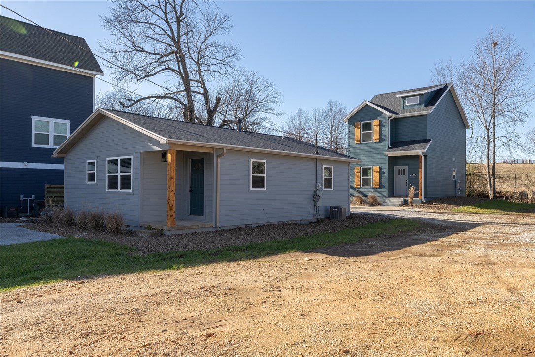 The perfect INVESTMENT opportunity in close proximity to the University of Arkansas campus!  Get 2 single family UNITS on 1 parcel.  
Main house “Unit A" is 854 heated and cooled sq ft and offers 3 bedrooms, 1full bathroom, eat in kitchen, living room, and stackable laundry.  House has been completely remodeled and is move in ready.  ADU “Unit B” is 1040 heated and cooled sq ft and offers 3 bedrooms, 1 full and 1 half bathroom, eat in kitchen, living room, and laundry.  This property is BRAND NEW and ready for occupancy!  Backs up to the ROAD HOG RV Park!