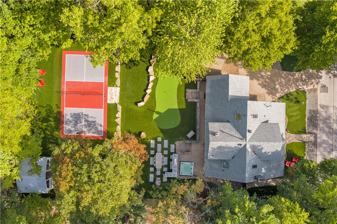 This fully renovated 1908 historic home is a proven, turn-key short-term rental property situated on a 0.31-acre lot just one block from Donald W. Reynolds Razorback Stadium and the University of Arkansas campus.

The 2,450 sq ft home features 4 bedrooms, 2.5 bathrooms, and charming vintage details paired with modern updates. Inside, you will enjoy a cozy gas fireplace, large living area, updated kitchen, and curated Razorback-themed decor for a fun atmosphere perfect for family and gatherings.

Another standout feature is the expansive backyard entertainment area, complete with a private pickleball court, 5-hole putting green, 6-person hot tub, and outdoor kitchen. It is an excellent space for entertaining and relaxing.

This fully furnished home is ready to enjoy in one of Fayetteville’s most desirable locations, ideal for homeowners, a second home or short-term rental investment.