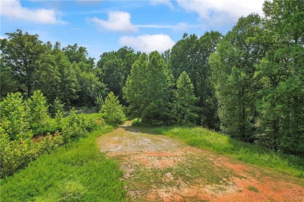 Are you considering building your secluded dream home or exploring development opportunities with these 9 acres? The potential is limitless, with water and gas already available at the street for your residential or commercial needs. Situated near HWY 12, with easy access to Beaver Lake and just minutes from downtown Rogers, this property offers seasonal views of beautiful Beaver Lake, which can be enhanced to year-round vistas with minimal effort. It features three level, cleared areas ready for construction, alongside two natural springs. The seller has conducted a survey and successful perc tests for at least three homes, if that aligns with your plans. This gated property includes a private drive access—contact us for a private showing.