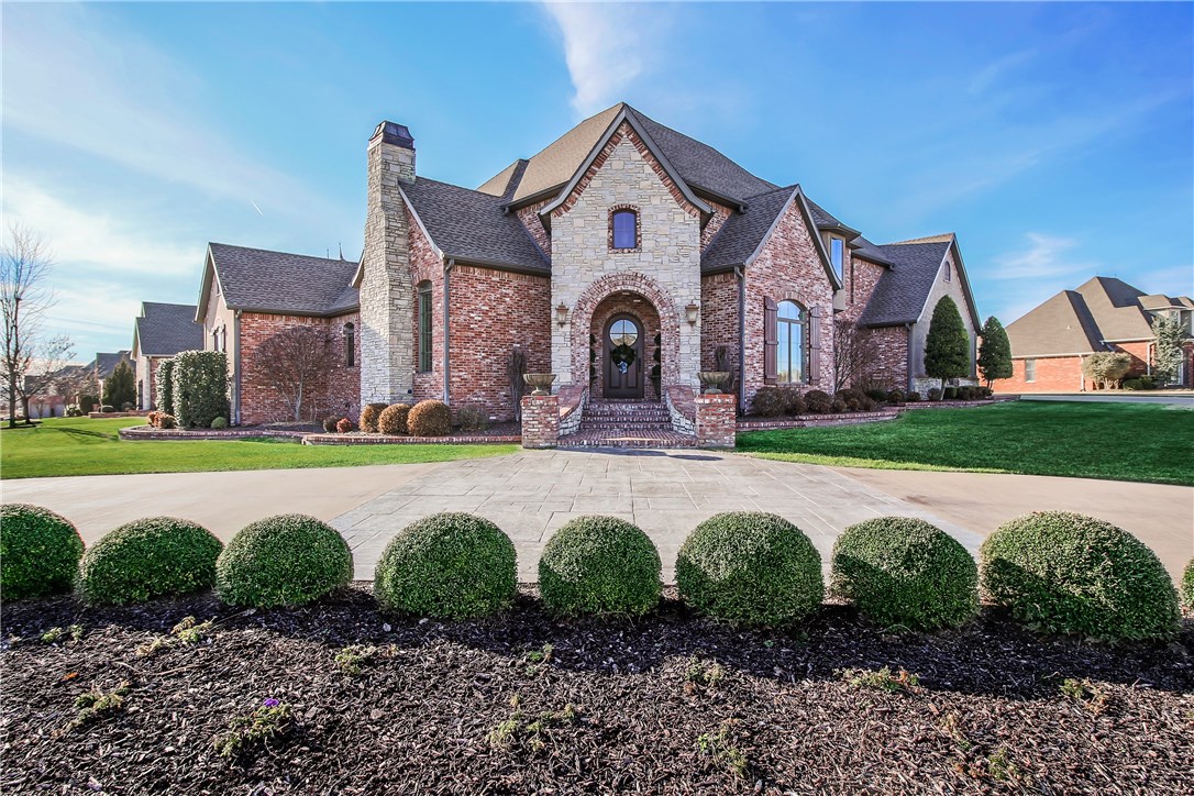 First time on the market!  This elegant custom-built Country French-style home in Pinnacle Country Club is situated on a 0.51 acre corner lot with front circle drive. Entertain formally in the stylish living room with limestone fireplace and vaulted ceiling with wood beams or in the intimate dining room with wet bar. The heart of the home boasts a two story family room, upscale kitchen with custom cabinets, center island, and top of the line stainless appliances. The main level home theater is a must see with stadium seating, Lutron scene lighting, & beverage center with ice maker. A private executive office features numerous built-ins. Recharge in the main level master with luxurious bath, his and her vanities, and walk in closet. The additional main floor bedroom has a full bathroom that doubles as a pool bath. Upstairs offers additional living space in the bonus room loft with half bathroom, storage closet, and veranda access. Two additional bedrooms with a jack-and-jill bathroom finish off the upstairs.
