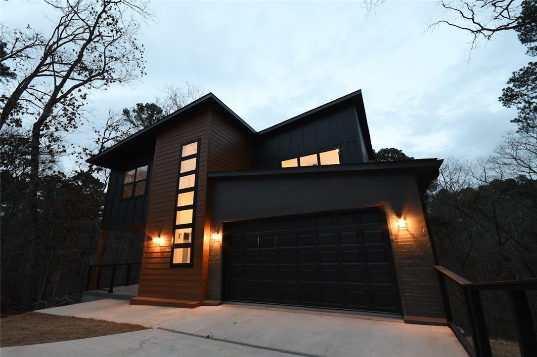 Refined Modern Luxury in a Private Cul-de-Sac Setting.Experience elevated living in this striking modern residence tucked away in a quiet cul-de-sac near the Back 40 bike trails, Lakes:Norwood & Ann. Thoughtfully designed with clean architectural lines,this home offers 3 beds, 2.5 baths,plus a private office.The open-concept layout delivers effortless flow between living,dining & kitchen spaces, enhanced by soaring ceilings & expansive windows filled with natural light. High-quality finishes & contemporary details create an elegant yet inviting atmosphere.A beautifully built rear deck ideal for entertaining pairs perfectly with a fabulous front porch adding charm & everyday comfort.The walkable backyard further sets this home apart. Surrounded by trails,lakes & the natural beauty of NWA,this home blends modern luxury,privacy & lifestyle-driven living.Photos are for illustrative purposes;finishes are similar to the completed residence.Taxes are estimated & subject to reassessment upon completion of new construction.