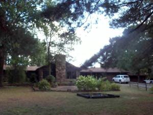 RUSTIC DWELLING --NATURAL BLENDING OF THE WARMTH  OF WOOD, ROCKS, STONE.  Country living in convenient location between Russellville and Lamar.  Home features  wood interior walls, hardwood and flagstone flooring. Kitchen offers a 6 burner Jenn Air cook surface plus large double ovens, new dishwasher. Lower den. Newer central heat and air systems. 3 car, 1500 +/- sq ft. oversized garage plus portable carport for that ski/fishing boat. Partially fenced back lawn is perfect for the canines. Park-like setting. SELLER IS A LICENSED REALTOR IN THE STATE OF ARKANSAS. Square footage is per courthouse records.