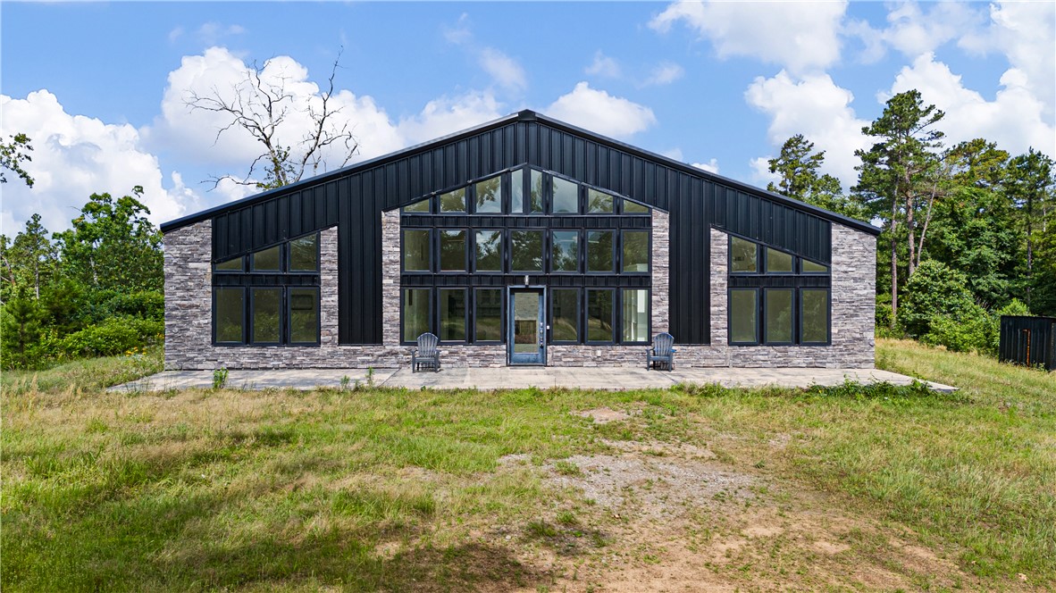 One-of-a-kind 40-acre retreat bordering the Ozark National Forest on 2 sides in the Arkansas River Valley Tri-Peaks Region. Perfect as a private getaway, hunting lodge, Airbnb, or full-time residence. Enjoy direct access to ATV trails, horseback riding, hiking, hunting, fishing, and endless outdoor recreation. Conveniently located near Mt. Nebo, Mt. Magazine, Petit Jean State Parks, Spring Lake, and Lake Dardanelle. Custom 2,400 sq. ft. home offers European-inspired elegance with a double-sided gas fireplace, 3 bedrooms, 2 baths, den/man cave, mud room, and spacious laundry room with exterior entrance. Upscale kitchen features granite countertops, quality appliances, and abundant cabinetry. New flooring and tiled showers throughout. Energy-efficient red iron steel frame construction with double insulation and premium windows. Stocked pond with crappie and catfish, food plots, blinds, feeders, firepit patio, fenced backyard, insulated 30x30 shop, camper storage.