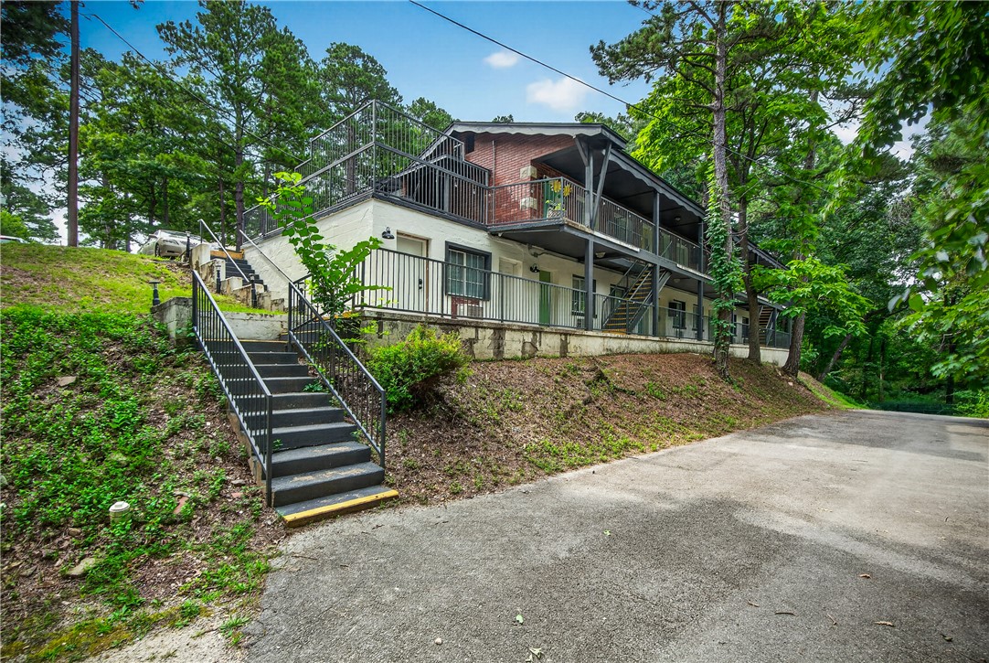 Rare 12-unit turnkey hospitality investment in Eureka Springs. Studios at Eureka currently offers a flexible hybrid income model with 6 short-term rental units and 6 mid-term rental units. Opportunity for new owner to turn this into a boutique hotel! Valuable grandfathered STR permit in a market where new STR permits are banned in residential zones. The property has been remodeled throughout: LVP flooring, updated furnishings, smart locks, HVAC repairs and replacements, plumbing and electrical updates, exterior paint, landscaping, and active branding across online booking platforms, and a direct booking site. This multi-unit Ozark property benefits from Eureka Springs tourism demand and nearby attractions. Property is fully operational with active STR bookings and mid-term guests in place. Value-add opportunities: hot tub, outdoor fire pit/gathering area. Don't miss this one! Financials and projections available upon request. Buyer to verify all figures, permits, income, expenses, and projections.