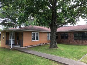 Check out this cute 3BR/2BA brick home at the edge of town. Large living room with gas fireplace, kitchen/dining combination with lots of cabinets. Two rooms for storage or workshop just off of garage are not included in square footage. Large level fenced backyard. Great location! This one deserves your attention.