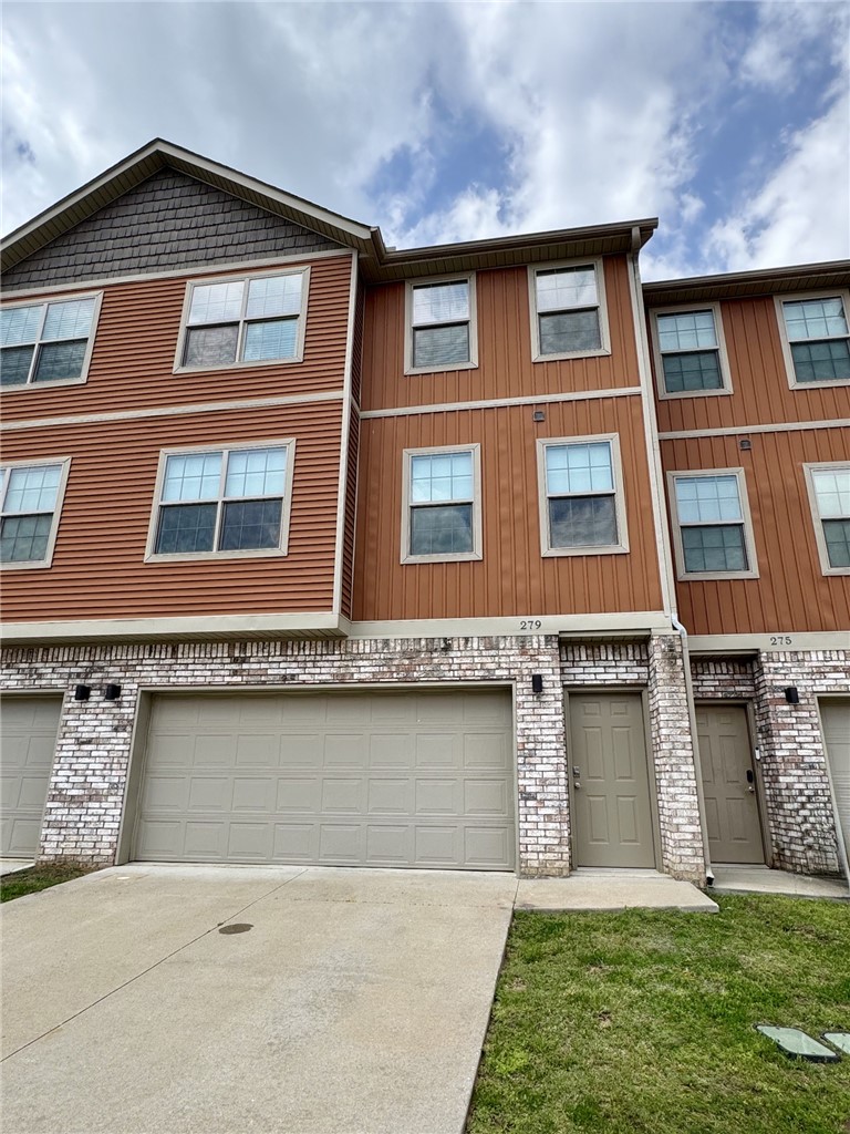 This townhouse is ideally located just minutes from the University of Arkansas campus and close to a wide variety of dining and shopping options. The three-level layout offers a garage on the first floor, with the main level featuring an eat-in kitchen, living room, dining area, and half bath. Upstairs, you’ll find two bedrooms, including a primary suite with a private bathroom and walk-in closet, along with an additional full bath and a convenient laundry area.
The kitchen is equipped with stainless steel appliances, granite countertops, and a center island. The home has been freshly painted and is move-in ready, with new flooring throughout, including pine wood stairs. A deck just off the kitchen provides the perfect space for outdoor dining or relaxing while enjoying the peaceful wooded area behind the property.