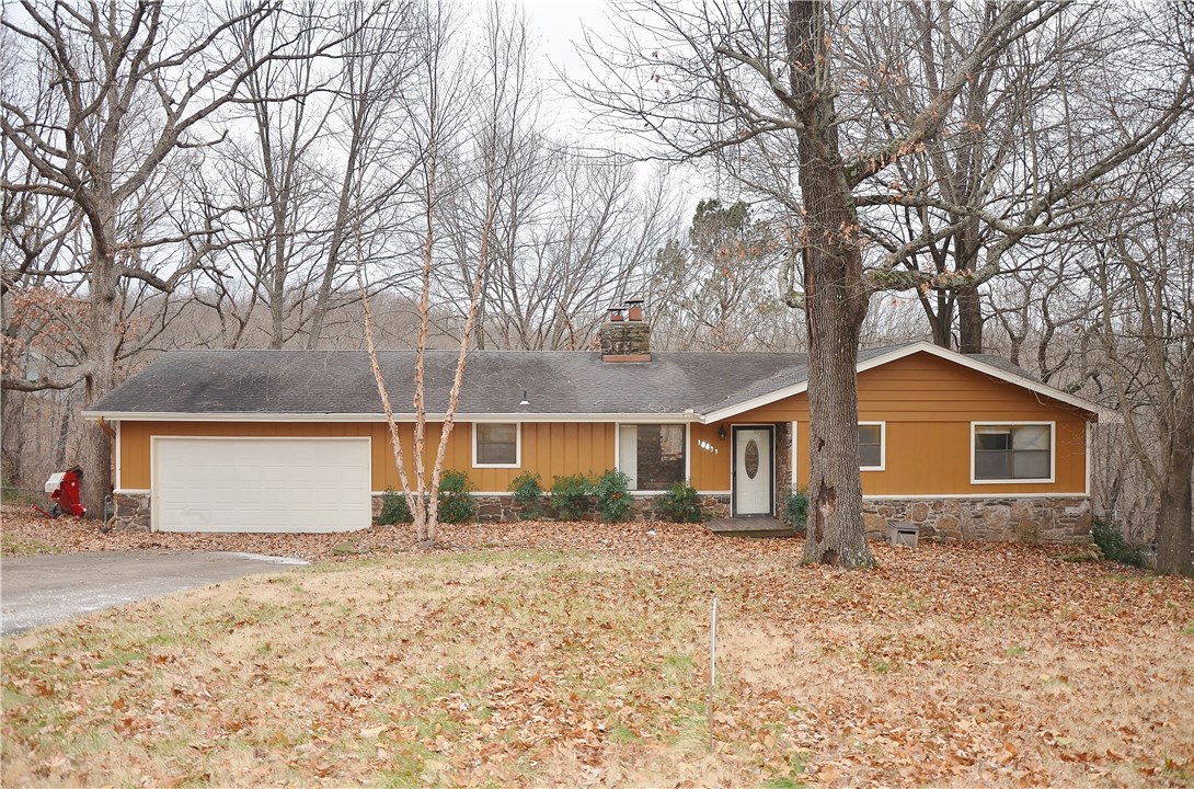 Spacious home in quiet Beaver Lake area neighborhood. So much potential to make this house into a one-of-a-kind gem. 2 spacious living areas. The basement family room walks out into the large backyard. The main floor living room has an inviting deck overlooking a peaceful wooded hollow. Office area with built in bookcase, perfect for a library or to show off collectibles, adjoins the main floor living area. Over-sized garage is large enough for 2 vehicles, with room to spare for the built in workbenches.