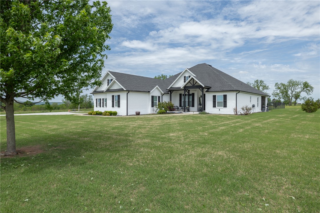 Beautifully updated home built in 2017, designed with a high-flow layout ideal for everyday living and entertaining. The spacious kitchen features a double oven and opens seamlessly to the main living areas, creating a welcoming and functional space. Enjoy year-round relaxation on the impressive screened-in porch, complete with a cozy fireplace. The primary suite features a well-appointed bath with a double vanity plus a dedicated makeup vanity, offering both function and everyday luxury. The large laundry room is thoughtfully designed with abundant countertops, a sink, and three convenient pull-out laundry bin drawers for exceptional organization. A dedicated safe room with electrical outlets adds both functionality and peace of mind. A detached 160 sq ft building provides flexible space for a workshop, hobby area, or additional storage. With modern updates throughout and a private setting, this property blends comfort, style, and practicality.