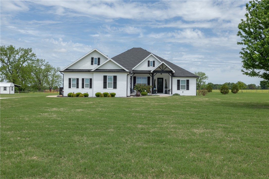 Beautifully updated home built in 2017, designed with a high-flow layout ideal for everyday living and entertaining. The spacious kitchen features a double oven and opens seamlessly to the main living areas, creating a welcoming and functional space. Enjoy year-round relaxation on the impressive screened-in porch, complete with a cozy fireplace. The primary suite features a well-appointed bath with a double vanity plus a dedicated makeup vanity, offering both function and everyday luxury. The large laundry room is thoughtfully designed with abundant countertops, a sink, and three convenient pull-out laundry bin drawers for exceptional organization. A dedicated safe room with electrical outlets adds both functionality and peace of mind. A detached 160 sq ft building provides flexible space for a workshop, hobby area, or additional storage. With modern updates throughout and a private setting, this property blends comfort, style, and practicality.