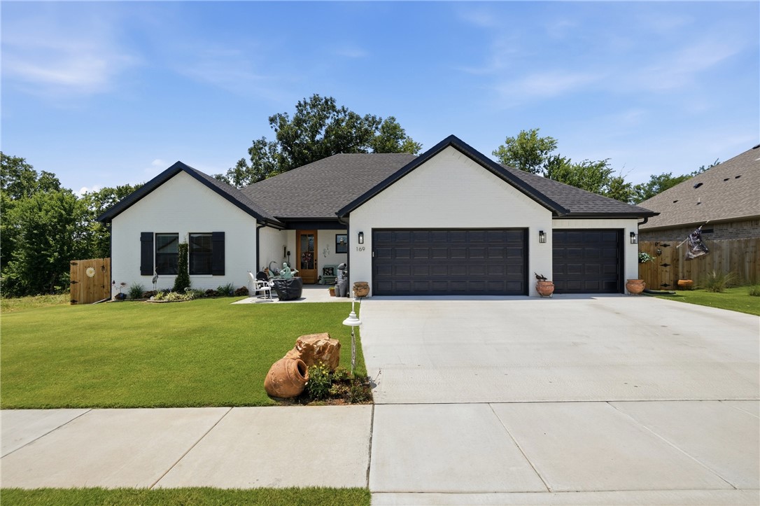 Welcome home to this exquisitely customized Home!  Settled toward the end of a cul-de-sac this homes construction completed in 2025. This immaculate home backs up to a scenic 165-acre cattle ranch offering breathtaking views and unforgettable sunsets. Inside you'll find cedar beams, mantle, and column in the living room, a real stone fireplace, black quartz countertops, a large quartz island, custom soft close cabinetry, a mother-of-pearl backsplash and bath tiling, designer lighting, a custom 9' front door, cedar pantry door, a 100-year-old reclaimed wood laundry door, brushed brass, and much more! The spacious primary suite features a luxurious custom tile shower, separate bath with mother of pearl tile, a large well laid out closet. Enjoy two covered patios, a fenced backyard with double gate, extra concrete, and a 3-car garage. Conveniently located just minutes from shopping, dining, and the University of Arkansas, this home offers an exceptional blend of craftsmanship, comfort, privacy, and stunning views.
