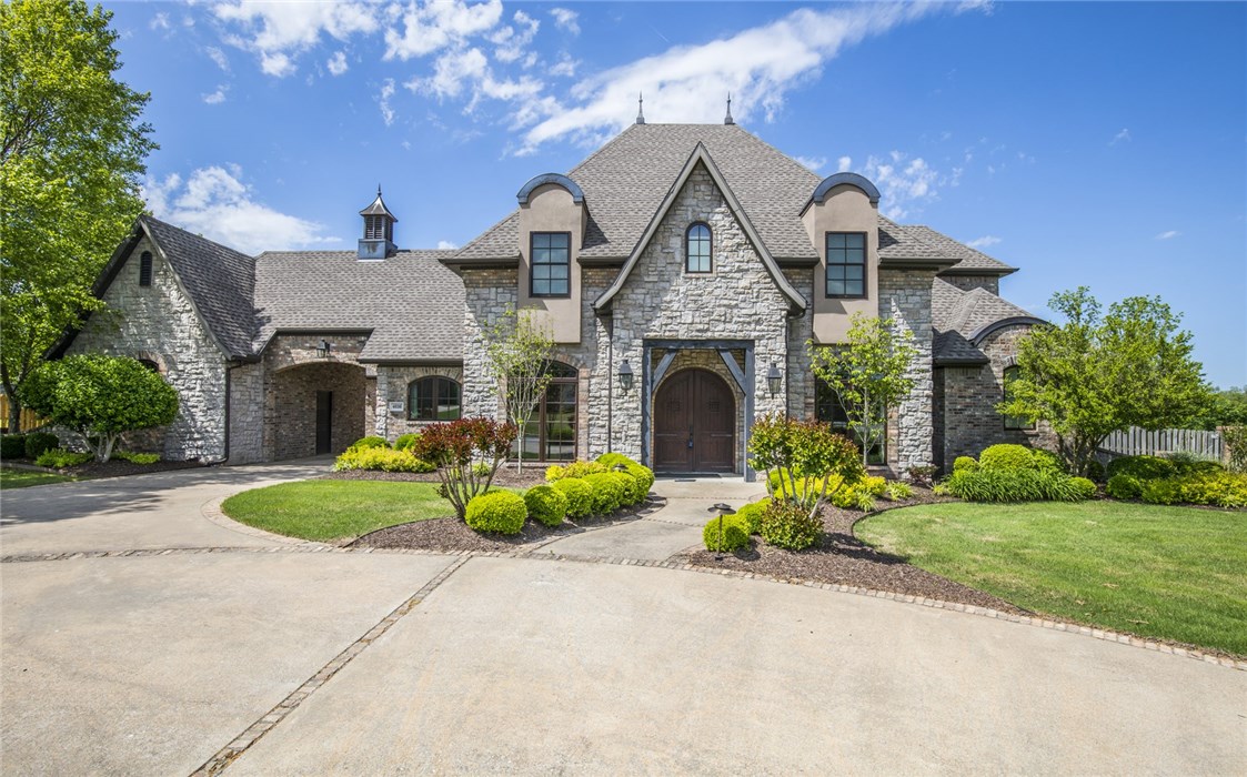 DREAM HOME ALERT! This is one of Northwest Arkansas’ most beautiful homes located in the prestigious St. Valery Downs gated community in a fabulous location off HWY 112 in Bentonville (across from Central Park Elem). Current owners added on what has to be the most amazing entertainment rooms around – opens up to pool area with an outdoor kitchen/indoors! Heated pool with waterfall/slide (newer liner). You will love entertaining and having family dinners/parties in this room! Gorgeous acre level lot (.97). Pool house (room/bathroom); mud room, multiple “flex rooms”… New Pella Architect windows throughout, new heat & air units, tornado shelter, new garage doors… Welcome HOME!