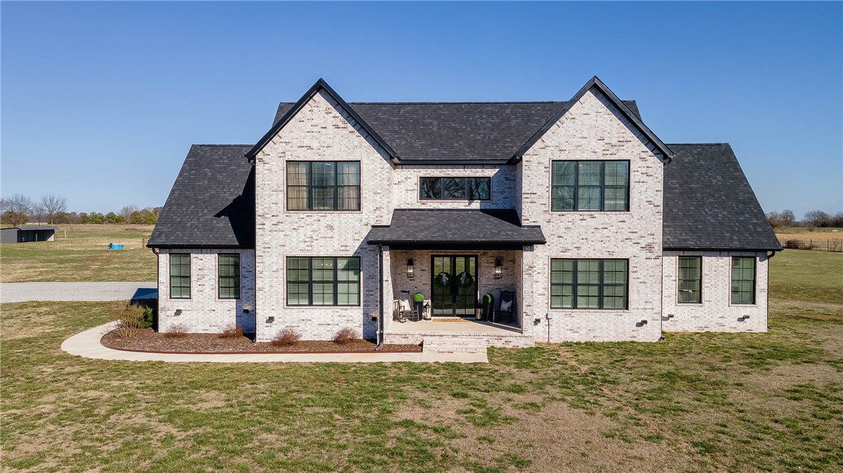 This stunning transitional modern farmhouse is the perfect mix of elegance & comfort, set in a beautiful rural location! With 3 beds, 3.5 baths, a bonus room that also serves as a flex space, formal dining room, & high-end finishes throughout, this home offers thoughtful design & premium details. The chef’s kitchen features Cygnet Drift Quartz countertops, a waterfall island, marble backsplash, pot filler, Frigidaire Professional appliances, butler's pantry, & soft-close cabinets. The primary suite is a luxurious retreat with a spa-like bath, soaker tub, & walk-in shower with double shower heads. A designated office with built-ins adds versatility, while a covered patio provides the perfect spot to relax & enjoy the scenic surroundings. Additional features include 8-ft interior doors on the main level, designer lighting, & a Dimplex linear fireplace. The oversized garage offers water access, & smart home features like Ecobee Bluetooth thermostats & a Ring security system add modern convenience. A true showstopper!