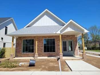 Sold before print - MLS listing only. Beautiful New Construction home in Downtown Bentonville. High ceilings, large windows, open main living area with hard wood flooring, kitchen features quartz and leathered granite, large island with stainless farm sink, and built in microwave, stainless appliances, gas range, refrigerator included, large custom pantry, has a butcher block counter. Large utility room with lots of storage and counter space, additional bedroom/office on main floor. Master suit is on main level and includes double sinks, large soaking tub and amazing walk in shower with bench, large walk in closet with built ins. 3 bedrooms and 2 baths up with open common area possibly a game room or 2nd living room. Detached 2 car garage, window cover will be installed.