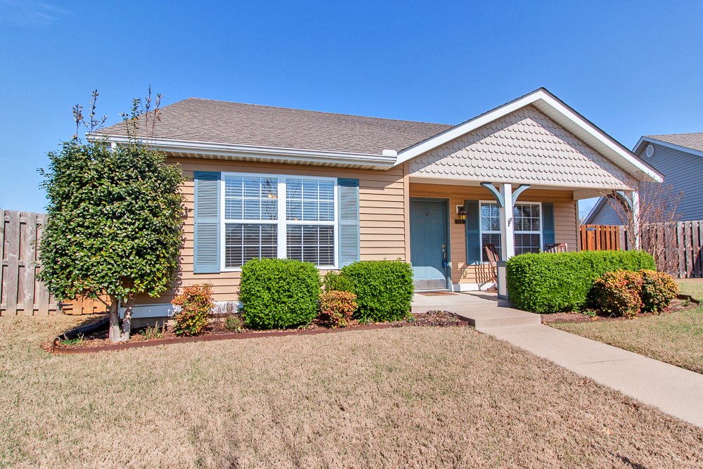 Make this Fayetteville home yours today! Located in a great community, 7 min from UARK, close to shops, I-49&right across from 4.9-Acre community park with walking trails & playground! Exterior features include covered porch, fenced yard&back patio for your grill! Interior features include open living room, kitchen with refrigerator, wood flooring, carpet & tile and more! Contact today to see this home!