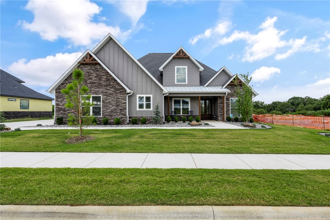 Stunning New Construction with a Best-Selling Floorplan in the sought after Big Sky Subdivision!  All the quality and extras you expect throughout from one of the top builders in NW Arkansas.  Large light-filled open living space featuring a gourmet kitchen with huge island, tons of cabinets, double ovens, gas cook-top and butler’s pantry. Downstairs also features the Master suite, formal dining, office or optional 5th bedroom.  Upstairs features 3BRS, 2BA and large media/game room with built-in wet bar.  Covered back patio, complete home security system and smart home wired. Professionally landscaped, sodded yard and sprinkler system. Home is complete and move in ready! No time to wait!