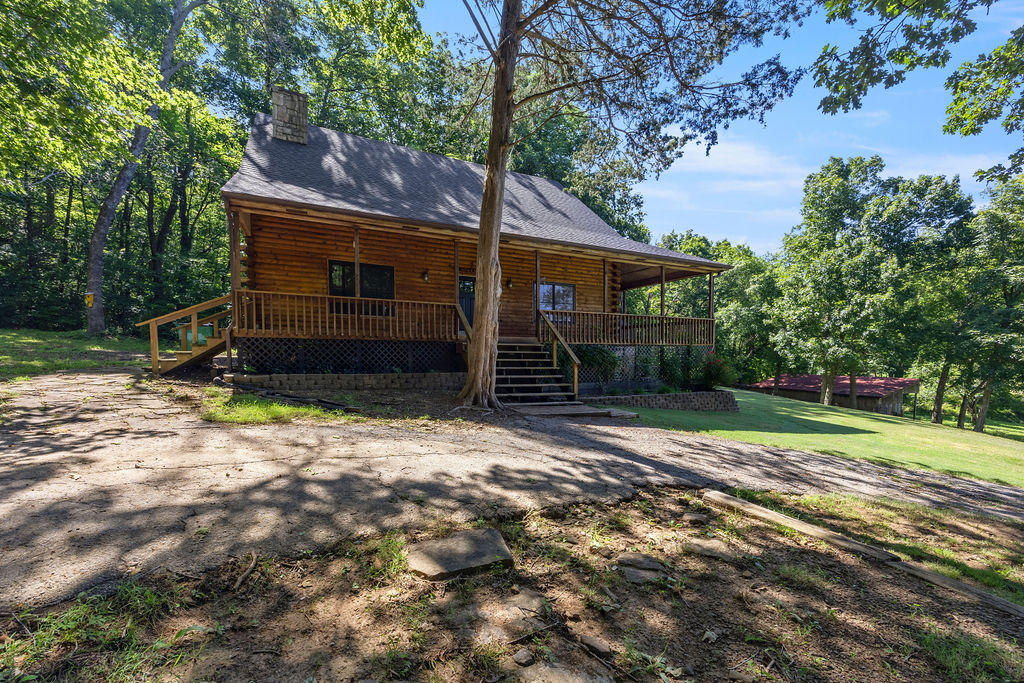 Gorgeous West Fork property! Updated log-sided home is nestled on 13.28 acres that is just outside city limits. Open-concept interior features a vaulted ceiling, large loft, cozy wood stove, and a handy mudroom with outside access. Cook with ease in the eat-in kitchen boasting granite countertops, an island, and a pantry. Spacious bedrooms with split bedroom layout. Primary suite offers walk-in closet and a large ensuite bath with jetted tub, dual vanities, and separate shower. Outside, take in pastoral views from the wrap-around porch, pergola, or firepit. Nature lover's dream, featuring a stocked pond (catfish, bass & crappie), creek and abundant wildlife. Storage shed, pole barn, and chicken coop—perfect for a hobby farm. Have peace of mind with new roof on the house and shed (spring 2026), plus an updated water heater, flooring, and Andersen windows. Enjoy the perfect blend of country living and city convenience. Just 5 minutes from Drake Field, schools, restaurants, and shopping. Must see this one today!