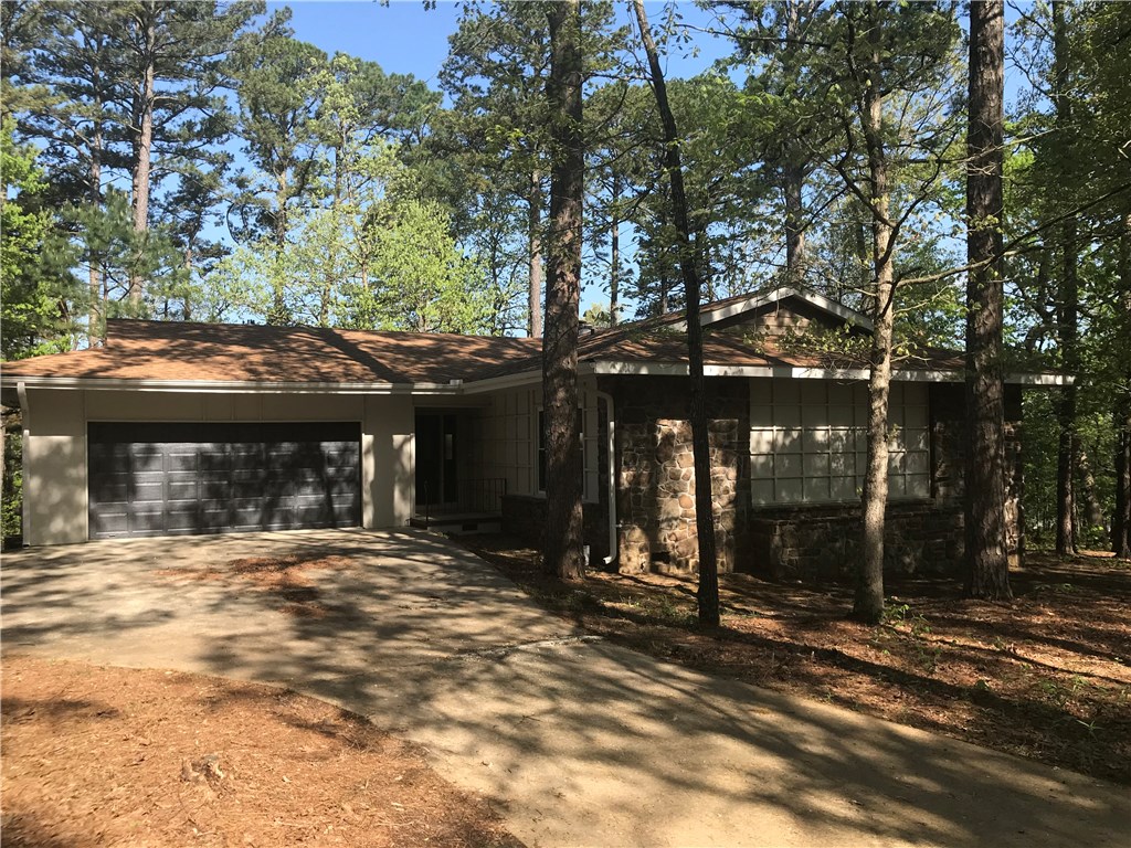 Major floor to ceiling refresh just completed on this 1440 square foot home sitting on a massive double lot in South Bella Vista just minutes to I-49 and North Bentonville. Nestled on a quiet, secluded, wooded, cul-de-sac drive, this home offers 2 master suites with loads of storage including 3 storage closets, laundry closet, oversized 2 car garage & a large unfinished space in basement perfect for a workshop, storage, etc. With new paint inside & out.