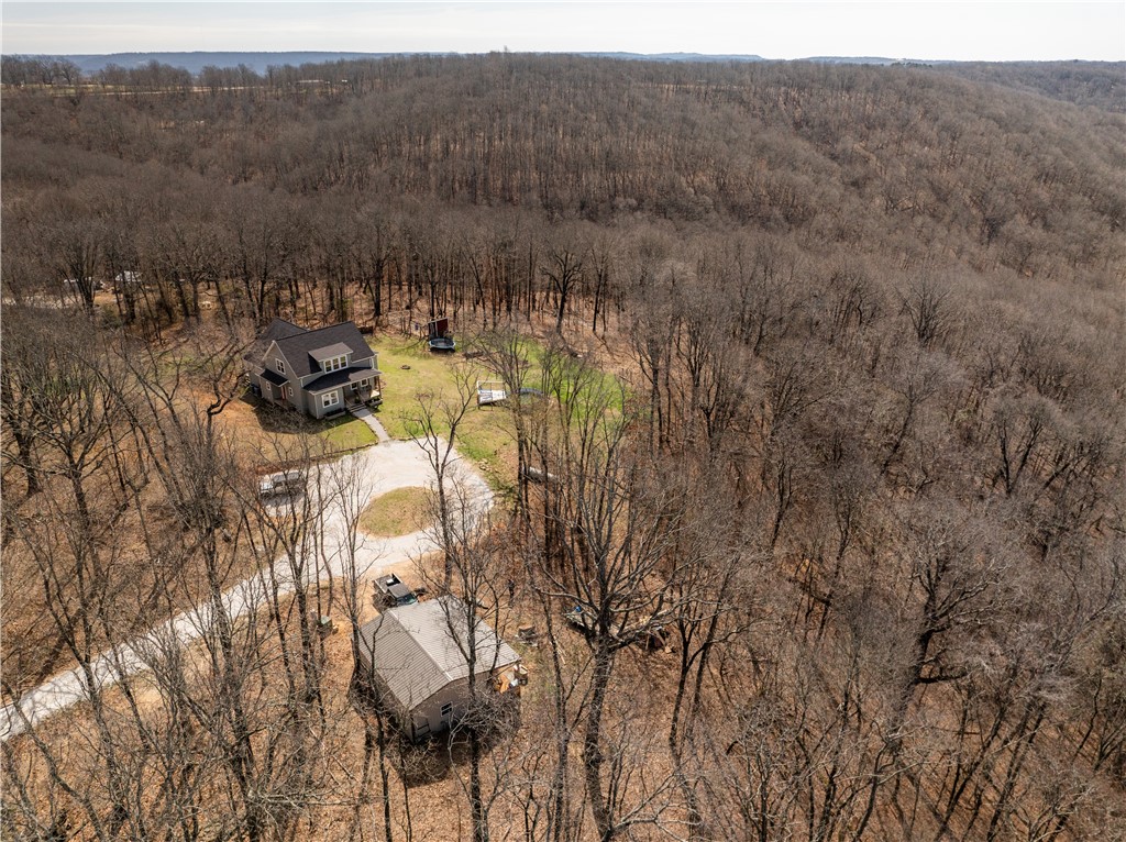 Escape to the peace and privacy of country living on just over 10 picturesque acres. As you turn off the highway onto one of the best-maintained gravel roads you’ll find, you’re welcomed by rolling green hills and open pastureland. This spacious 5-bedroom home offers flexibility for everyday living, a retreat, or hobby farm potential. The land features both a wet weather creek and a year-round creek, creating a serene, nature-filled setting. Outdoor amenities include a detached garage, above-ground pool, chicken coop with fencing, and an established garden with rich organic soil. With usable acreage, natural beauty, and a private yet accessible location, this property is ideal for those seeking space, functionality, and a true country lifestyle.