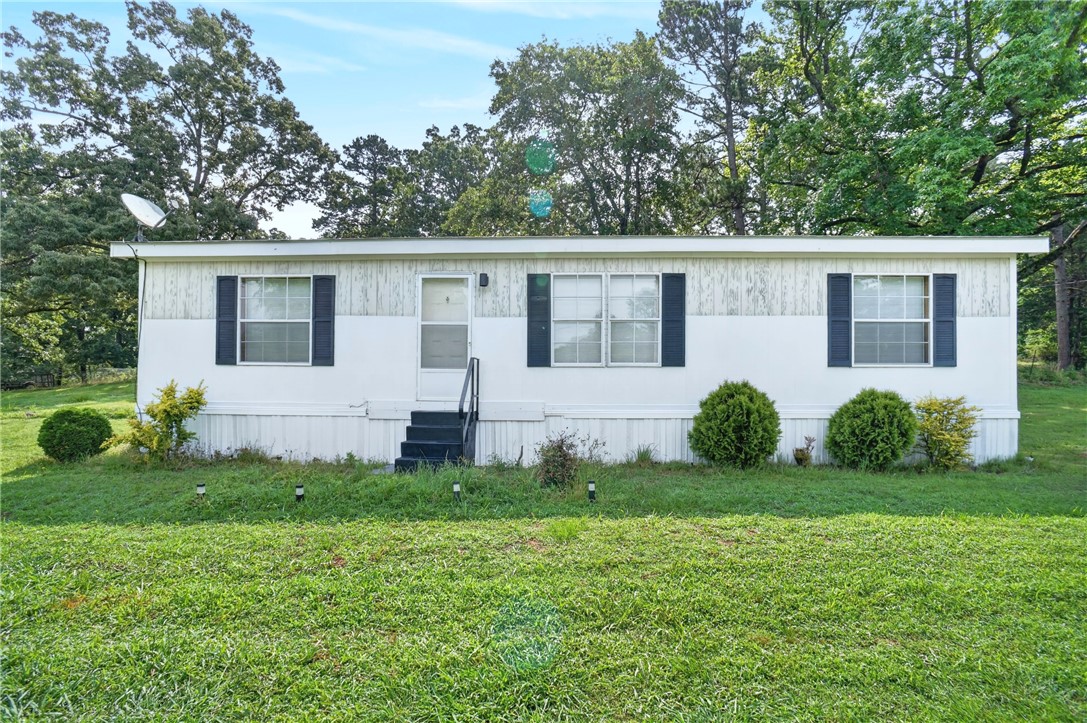 If you have been looking for a place that is close to town yet in the country that won't break the bank then 20 White Road may be just what you need.  It is just under 1200 sq feet with three bedrooms and two full baths.  It has a l large living room with a spacious kitchen complete with plenty of cabinet space.  The yard is a corner lot that is just shy of one acre.  Located in the highly sought after Mill Creek community it is perfect for any one looking to get out of town and still be 10 minutes from everything.  It was manufactured in 1996 so it can only be purchased with cash or an in house bank loan.  Also there are exclusions listed in the internal remarks.