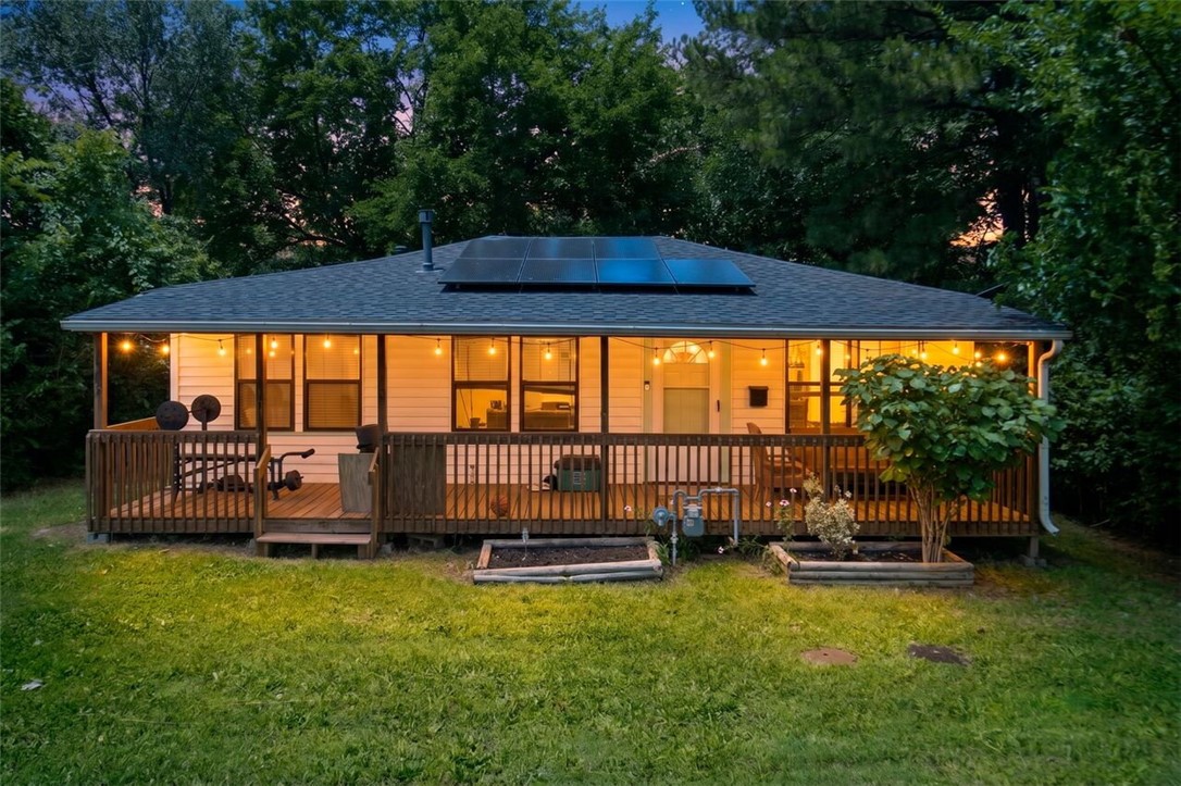 Charm, character, and an unbeatable location define this Fayetteville home less than a mile from the University of Arkansas. Walk to campus, catch the bus with a stop right outside your door, or enjoy quick access to Dickson Street, the Fayetteville Square, and the Farmers Market. Inside, three bedrooms offer flexible living options, including one that connects to another—ideal for a home office or bonus room. Luxury vinyl plank flooring runs throughout, along with a full bath and convenient half bath. The refrigerator, microwave, combo washer/dryer, and backyard storage shed all convey. Outside, a fully fenced backyard shaded by mature trees creates a private retreat perfect for entertaining or relaxing. Paid-off solar panels convey with the home and helped keep 2025 electric bills at an average of just $35 per month. A roof replaced in 2020 and a newer water heater provide added peace of mind. Move-in ready and full of character, this is a rare opportunity in one of Fayetteville's most desirable locations.