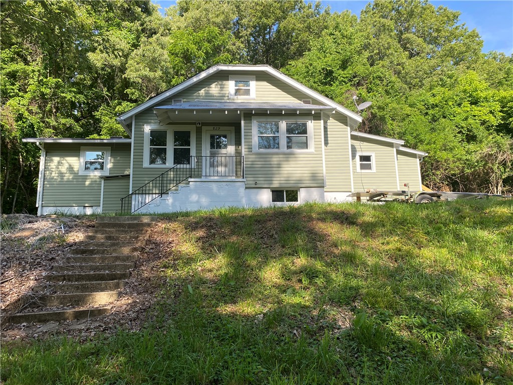 Nicely reconditioned home with interior refinished. Hardwood and laminate floors. New range refrigerator, roof, siding and windows. Detached garage has opener.