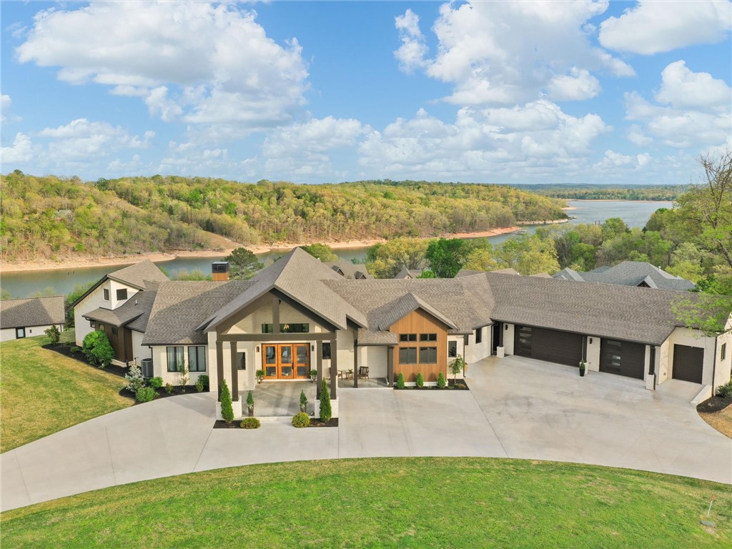 Exceptional Lake estate with elevated views of Beaver Lake on 3.55 acres in the gated community of Lakeway 20 minutes from Rogers . The property comes with two slips in a co-owned dock. This property includes two residences. The main home is 4500 square fee on 1 level with 3.5 garage bays  and the second home has 1500 square feet on 1 level and 5 garage bays. 4 of which are extra tall. Both homes have beautiful views.