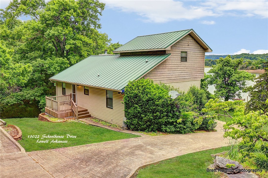 A great lake home within 15 minutes of Springdale or Fayetteville!  This home includes a very easy walk to a private 1 slip boat dock; open floor plan in living, dining and kitchen; 3 bedrooms; family room with wet bar and game room!  Updates include a newer roof, HVAC, flooring and hot water heater.  This home would make a great full time or part time lake place.  Short drive to Hickory Creek park and marina.