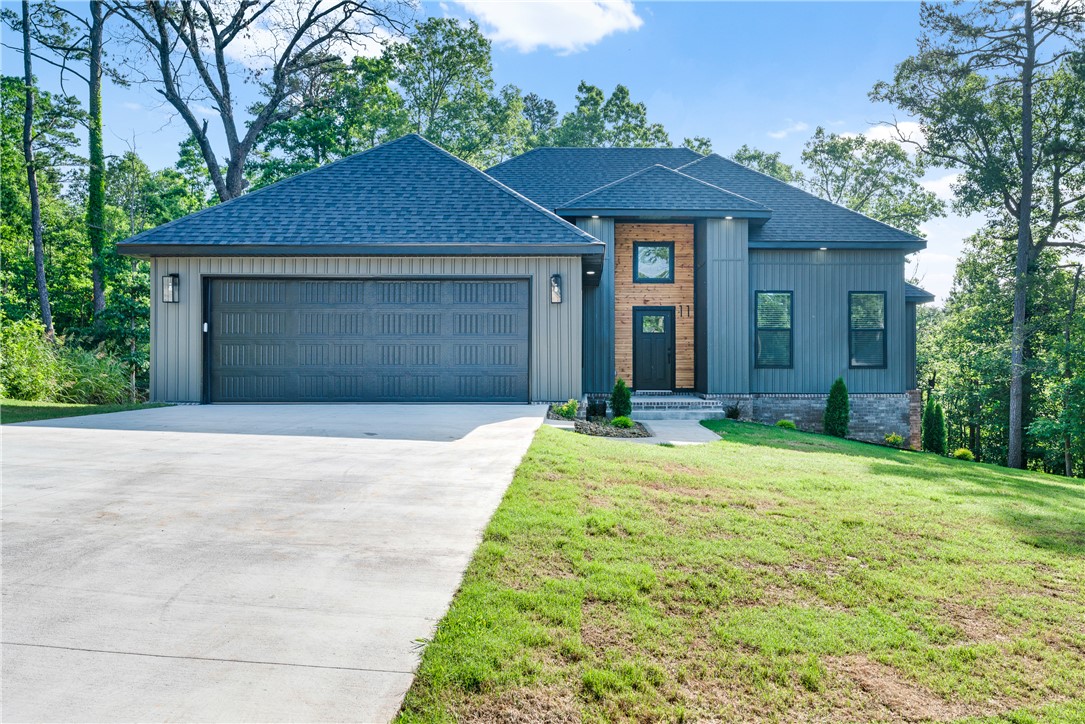 Experience the appeal of new construction in Bella Vista with this thoughtfully designed home featuring an open-concept layout ideal for modern living. The living and dining areas flow seamlessly into a stylish and functional kitchen, while direct access to the deck creates the perfect space to relax, entertain, and enjoy the scenic views. A spacious primary suite with a private bath, soaking tub, and walk-in closet is complemented by two additional bedrooms, offering flexibility for family, guests, or a home office. Outdoor living is enhanced by a spacious backyard that offers plenty of room for relaxation, entertaining, and enjoying the scenic surroundings. Conveniently located near Bella Vista's renowned trails, lakes, golf courses, and recreational amenities, this home combines comfort, convenience, and the beauty of Northwest Arkansas living.
