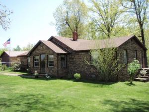Pretty little 3BR/1BA brick farm house with out buildings, fruit trees, garden spot and 2 acre pasture in a lovely rural setting only minutes from Harrison.  4' Chainlink fenced yard around the home and some fencing around the pasture area.  30 x 18 with 3 stalls pole shed, 10 x 18 stone garage/building, storm cellar, 18 x 18 animal loafing shed/building.  Beautiful mature oak trees and flowering shrubs, a rear covered patio and a small enclosed front entry give this home an inviting atmosphere.  The home has had a new 30 year roof installed in 2015, new door knobs in every room and outer doors, kilz paint on every wall so it's waiting for your color scheme, new screens and storm door on the front.  Pantry off of the kitchen and a utility room complete this lovely home,  better hurry!