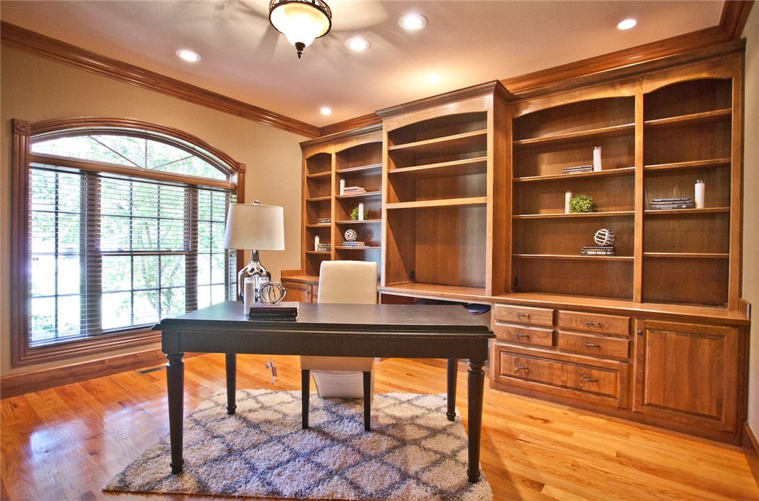 This stunner in Bentonville will blow you away. Enjoy the majestic acre lot! Inside you'll love the huge spaces! From the booming laundry room, kitchen, closets, two living rooms and even the enormous bonus space with wet bar to do as you please. Work from home? Treat yourself in the executive level office. Bring the basketball game to your house on your very own basketball court or train the next MJ! In the winter, work out in your very own workout room. It's the total package!