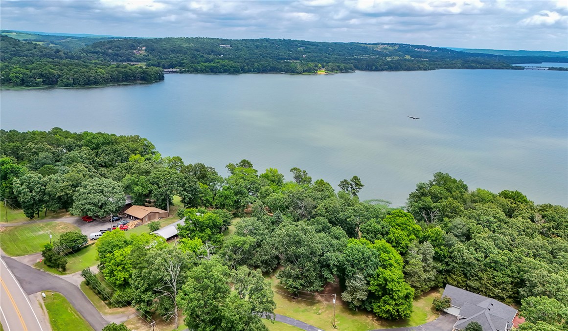 Lakefront Living! Wake up to water views and enjoy coffee on the deck of this charming 3-bedroom, 2-bath lakefront home. Nestled on the shoreline, this property offers the perfect blend of comfort, relaxation, and outdoor enjoyment. Step inside to a spacious living room featuring a cozy fireplace—ideal for gathering with family and friends on cool evenings. The inviting floor plan provides plenty of natural light, three comfortable bedrooms, two full bathrooms, and ample space for both everyday living and weekend getaways. Outside, enjoy dipping your toes in the lake, or simply relaxing by the water. Whether you're looking for a year-round residence, vacation retreat, or investment opportunity, this lakefront gem offers everything you need to enjoy the waterfront lifestyle.