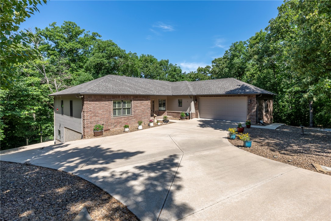 Tucked among mature trees on 1.28 acres, this OAK custom-built home invites a lifestyle of peace, purpose, & possibility. Morning coffee feels different in the sunroom—surrounded by treetop views that change w/the seasons—then spills out onto composite decking built for slow evenings & quiet reflection. Thoughtfully designed with 9’ ceilings, Pella metal-clad windows, geothermal heating/cooling, & instant hot water, the home blends comfort w/craftsmanship. New roof (summer ‘25) adds peace of mind. The heated & cooled 1,000+ sqft workshop is a dream come true—professional grade woodworking equip, high-ceilings, well lit, & accessible to the covered porch & paved drive, making this shop a year-round attraction. The partially finished lower level offers an office, 1/2 bath, utility room, & flex space, w/the potential to add finished flooring to increase overall square footage & value. This is more than a home—it’s a place to create, unwind, & truly live.  Home pre-inspected. *Seller to offer up to $10k in Concessions*