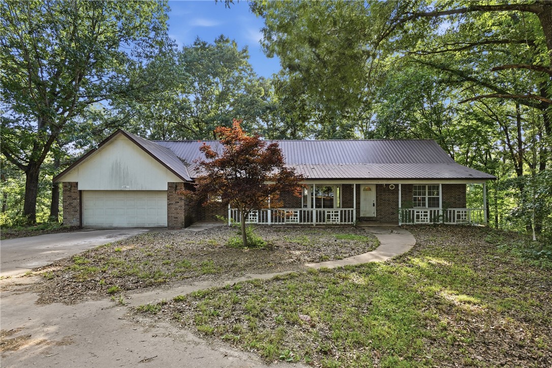 Nestled on 6.06 private, wooded acres, this property offers a rare opportunity for renovation, investment, or future development. The home is a complete renovation project. The acreage also offers the potential to be split (buyer to verify), adding flexibility. The spacious floor plan includes a full walkout basement with a second kitchen, ideal for multi-generational living, guest quarters, or additional living space. A loft overlooking the main living area provides the perfect spot for a home office, reading nook, or bonus room. A new main-floor HVAC system was installed in January 2026 & includes a transferable 10-year warranty. Located just 10 minutes from downtown Rogers, only 1 mile from the Beaver Lake/Monte Ne boat ramp, & within the desirable Rogers School District, this property offers the perfect balance of privacy & convenience. Complete with a natural spring, mature trees, & endless possibilities, this is an exceptional opportunity to transform a unique property in a highly sought-after location.