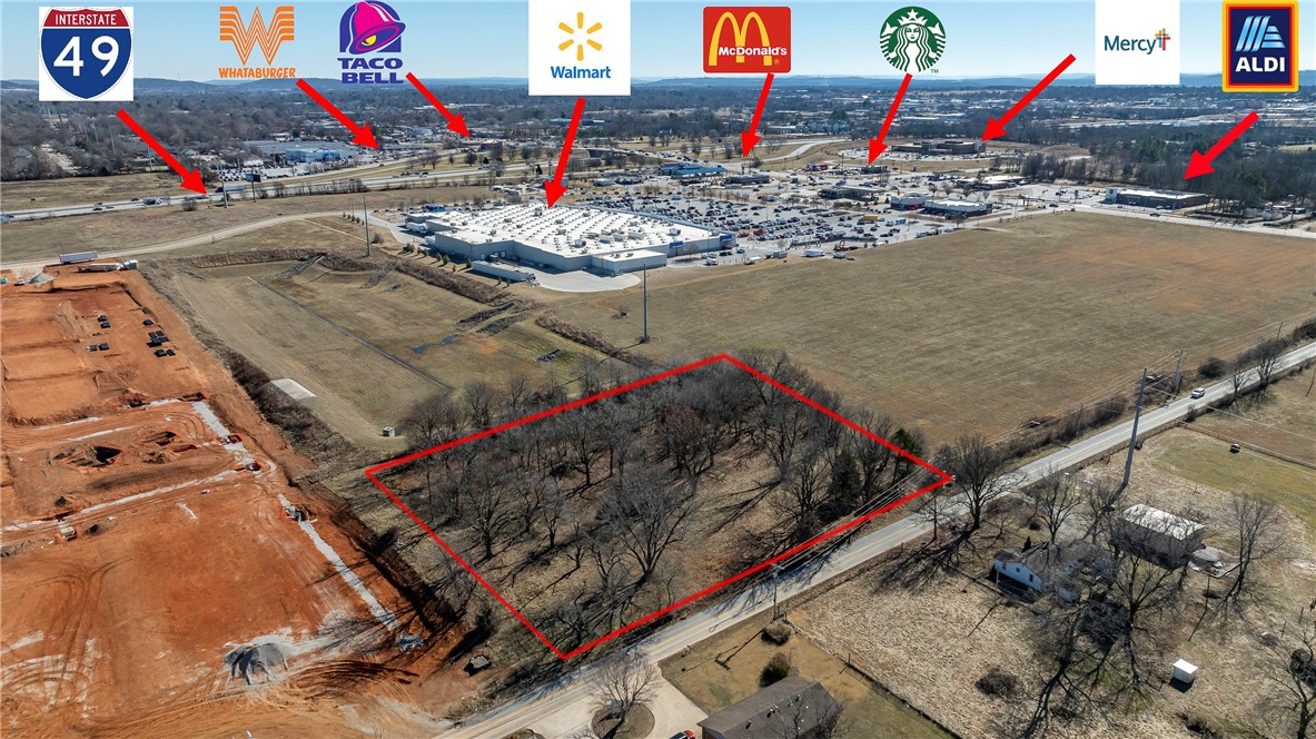 Prime Land. Per county records, any and all buildings on property were professionally torn down in 2017 along with septic tank filled. Two lots for sale side-by-side can be sold together or separately: #1307 with 1.68+/-acres & #1309 with .5+/-acres, totaling 2.18+/-acres, prime use could be development, commercial or retail. Vacant land adjacent behind Walmart Super Center, Arvest Bank & Retail space and located within a minute off a major interstate of I-49 and Elm Springs Rd exit to Oak Grove Rd.  Now also near Starbucks, Mercy Hospital, Aldi Grocery and Storage Untis.  Neighboring property is being developed into 300+ Apartment Complex that should be completed in 24-months or less.